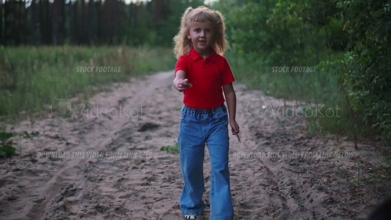 Little girl is running with her big black dog on the way in the meadow and smiling
