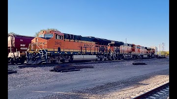 BNSF fast moving intermodal with JB Hunt containers passes through Belen NM Railrunner station