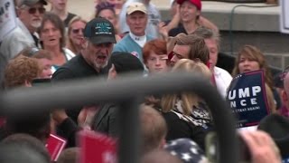 Protester shoved by Donald Trump rally attendees