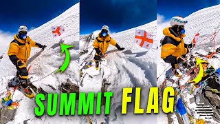 Climber Places a Flag After Reaching the Summit of the 4th Highest Mountain