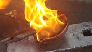Traditional blacksmith finishing forged projects with beeswax