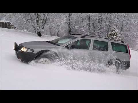 Volvo XC70 in deep snow. Volvo AWD. Winter drive uphill.