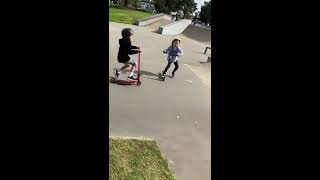 Boy on scooter crashes into girl at skatepark