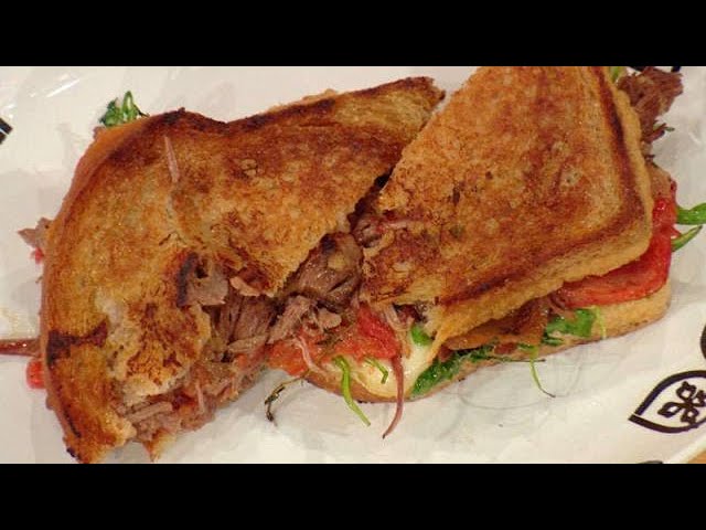 Griddled Braised Beef Sandwich with Caramelized Onions, Tomato Jam, Arugula and Taleggio | Rachael Ray Show