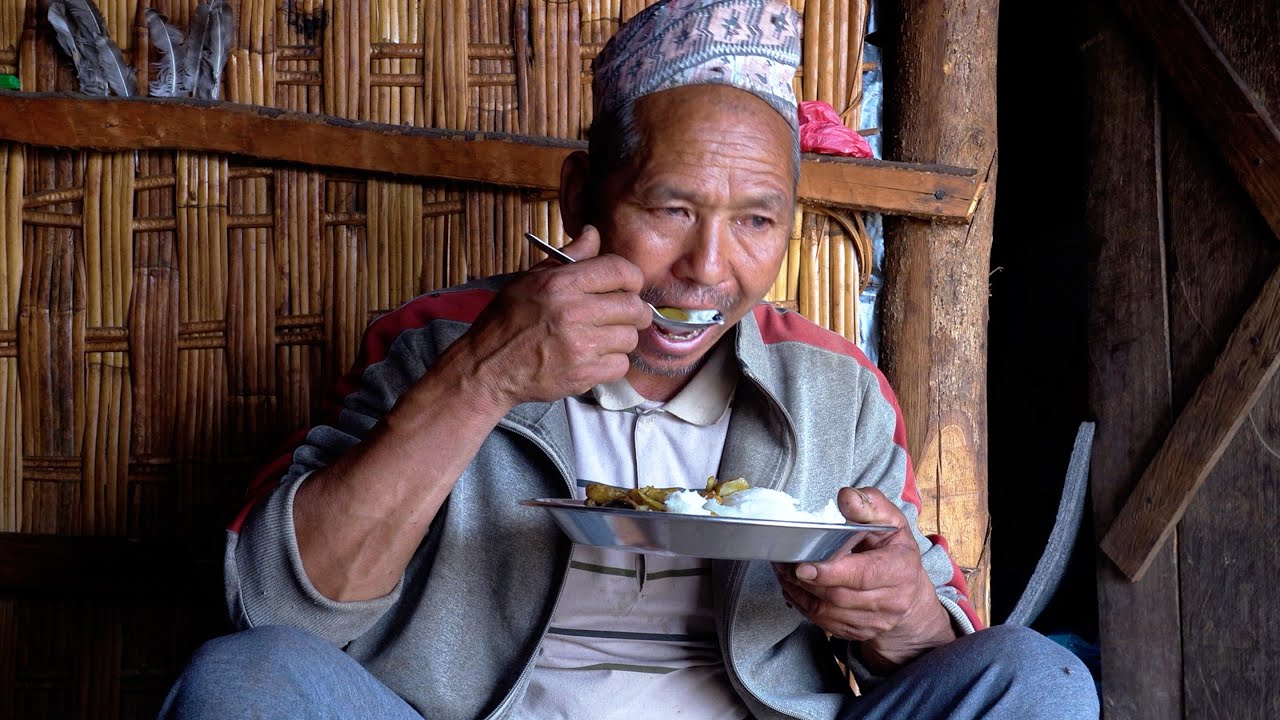 jungle man having lunch cooked by his daughter 