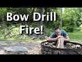 Making  lighting a bow drill fire primitive survival fire by friction