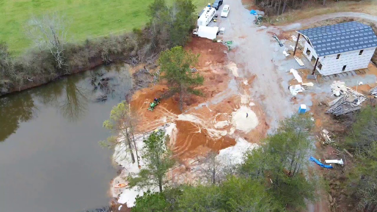John Deere 1025r helping change our muddy clay mess into a beautiful sandy beach. YouTube