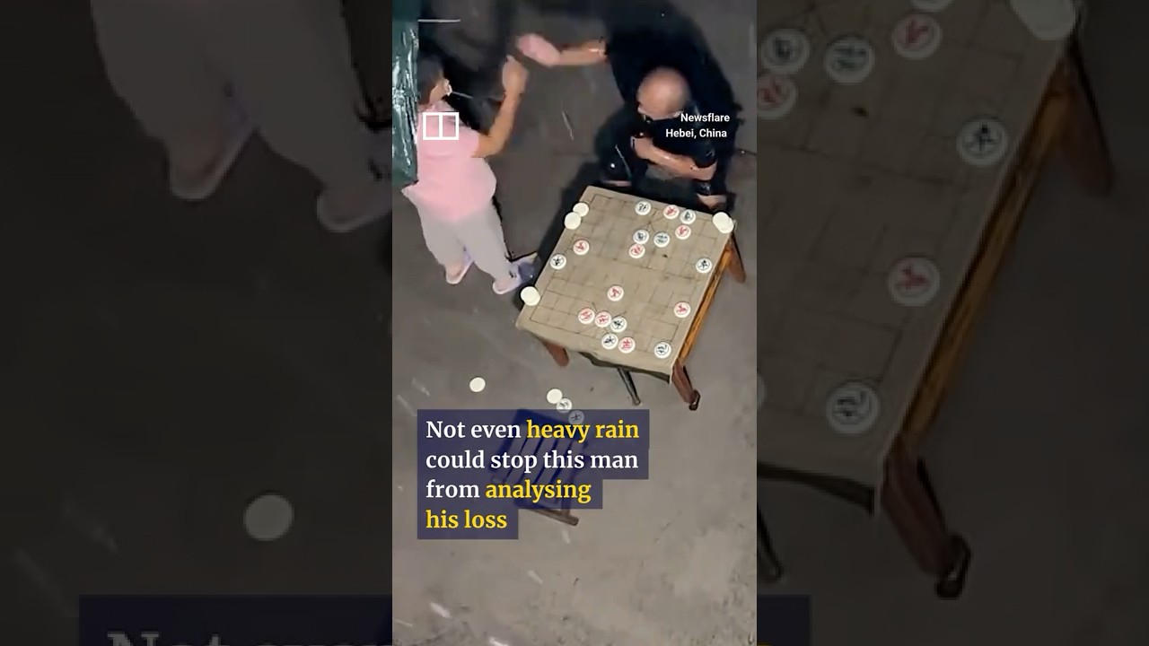 Chinese man loses in chess then analyses game for 4 hours in rain 