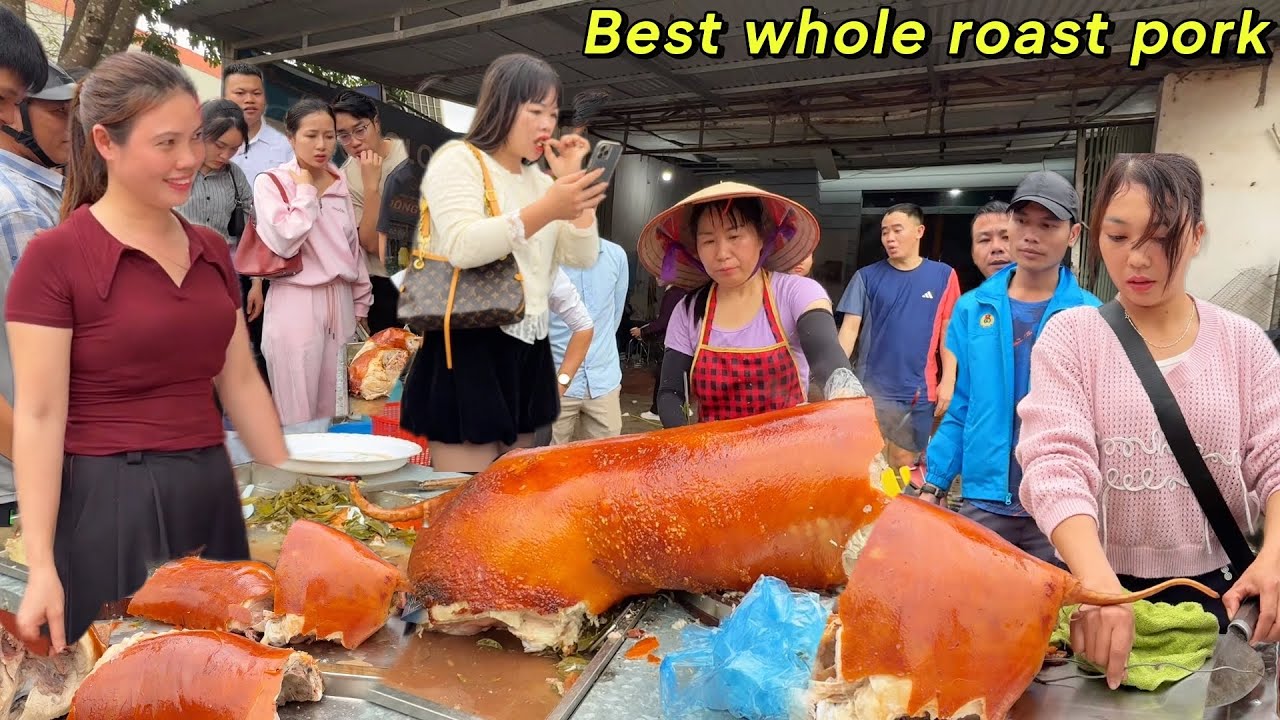 a close-up view of tourists scrambling to buy delicious whole roasted pork at a festival in northern