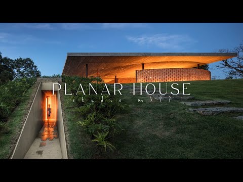 Une maison design qui radicalise les lignes horizontales avec un toit en béton recouvert de gazon