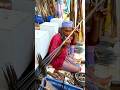An elderly man skillfully made a fish trap from thin bamboo.