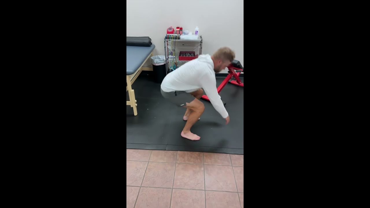 Limited squat with forward lean demonstrated in the clinic