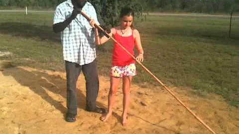 Alli throwing a spear at Katherine