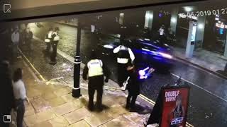 Car drives down crowded Wind Street in Swansea