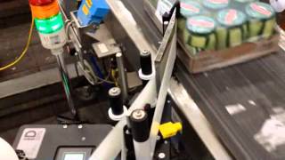 Model ST1000 Label Applicator Wipes Labels onto the Side of a Tray of Pickles