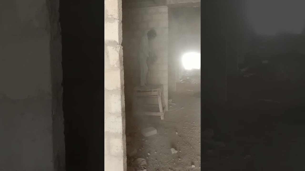 Wall Chiseling with hand grinder machine labour hard work in a construction Project