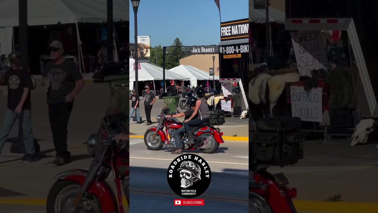 Couple With Harley Davidson Fat Boy Red On The Street