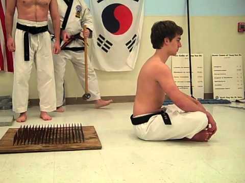Breaking a cinder block on a bed of nails - YouTube