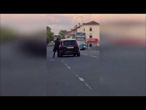 Bizarre footage shows shopkeeper chase out armed attacker by whacking him with a broom