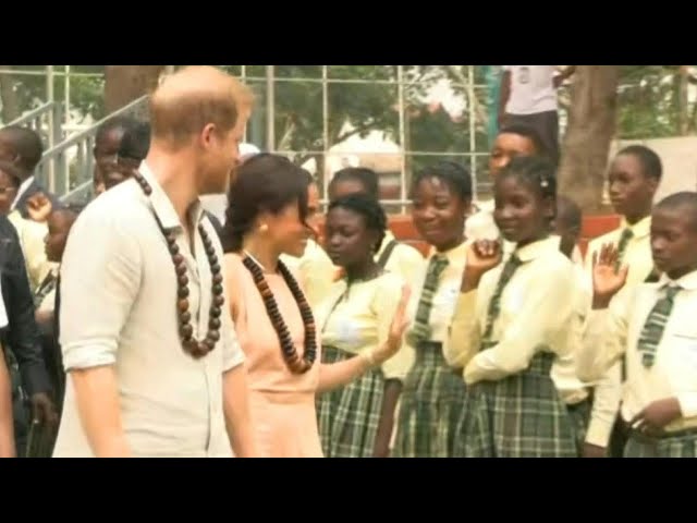 Prince Harry and Meghan leave school in Abuja after kicking off a mental health summit | AFP class=