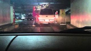 Riverpark Square parking garage vs lady in pickup with kayaks/canoes on top.