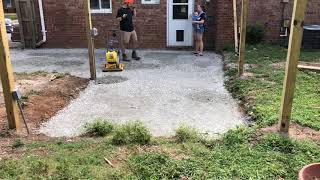 plate compacting crushed gravel base before paver patio installation