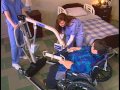 Transferring a patient from wheelchair to bed with a Reliant 600 and full body sling.