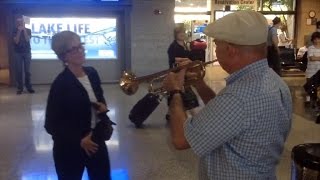 Man Plays Trumpet to Greet Wife of 33 Years in Heartwarming Airport Reunion