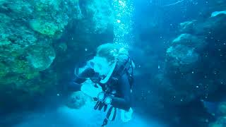 Scuba diving through a tight squeeze and controlling my buoyancy.