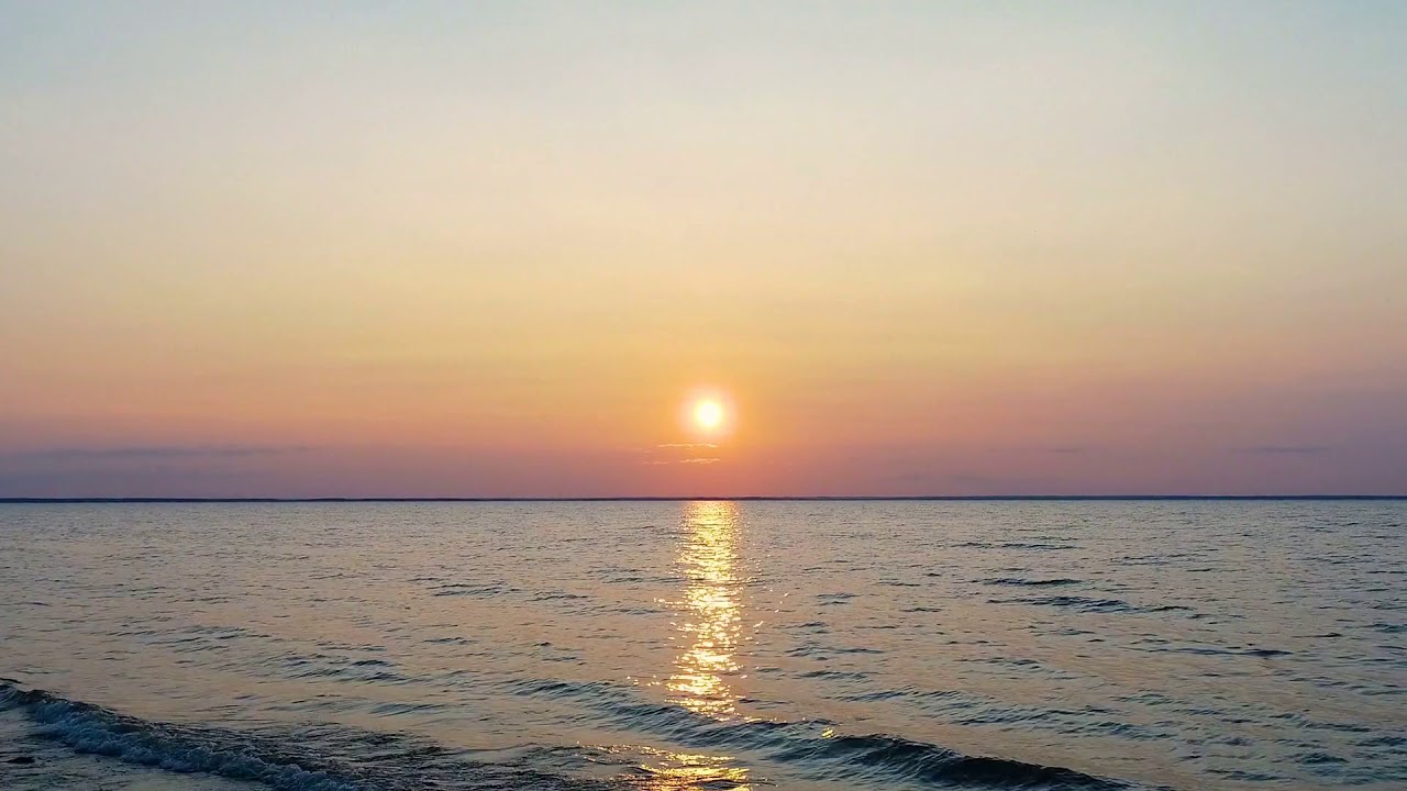 the flight above the water on the dawn background drone shot