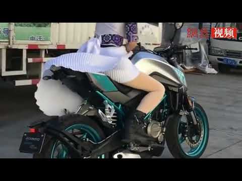 biker girl in a skirt takes off on sports bike