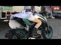 Biker girl in a skirt takes off on sports bike