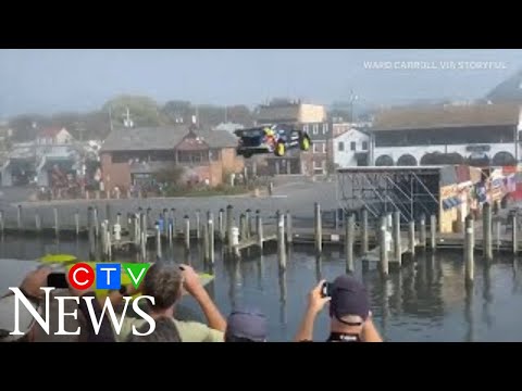 Watch a stunt driver clear a Maryland waterway in a car over a speeding boat