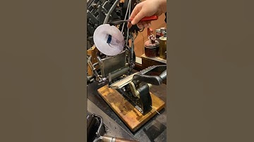 Using a tabletop printing press to print an image of a wooden printing press