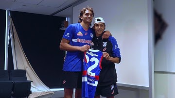 Jamarra Ugle-Hagan presents Arty Jones with his first AFL Guernsey
