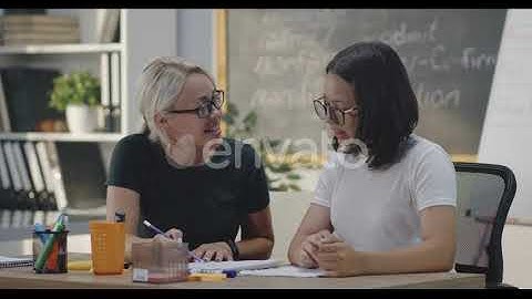 Teacher Explaining To Student in a Classroom | Stock Footage - Envato elements