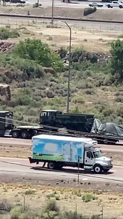 Military infantry support vehicle traveling on back of semi trailer