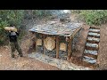 Primitive bushcraft shelter in the rain forest  stone roofed and stone wall