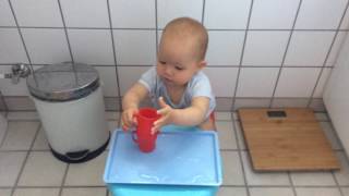 Baby FECS trying out Montessori pouring activity for the first time (1Y1M23D)