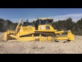 Komatsu D155 AXi ripping and loading scrapers