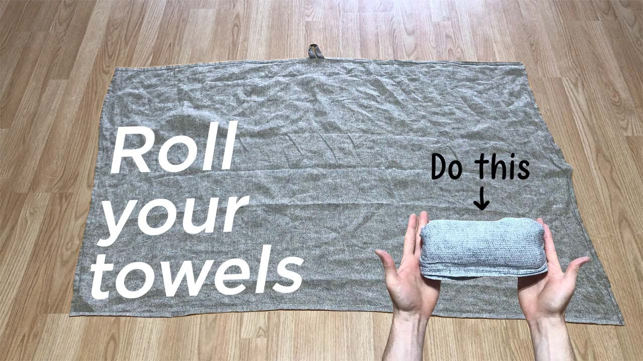 How to roll a towel for packing (step-by-step).