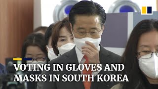 South Koreans don face masks, plastic gloves to vote amid Covid-19 crisis