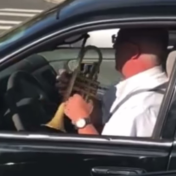 Marine plays trumpet in traffic. Semper Fi