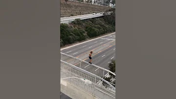 Risky walk on a bridge over Pacific Coast Highway, Santa Monica, California. Would you ever do this?