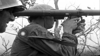 US soldiers of 305th Infantry, 77th Division on ridge fire bazooka into cave in o...HD Stock Footage