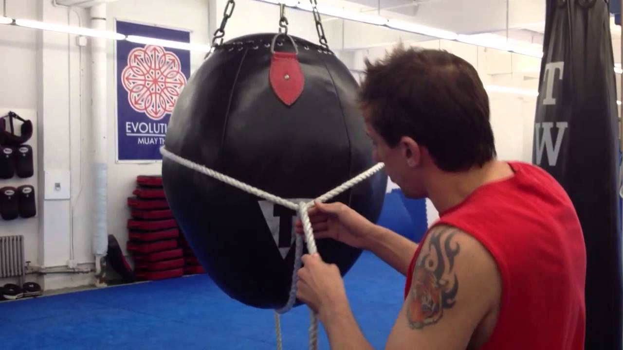 Tying the back string on the Thai cup.