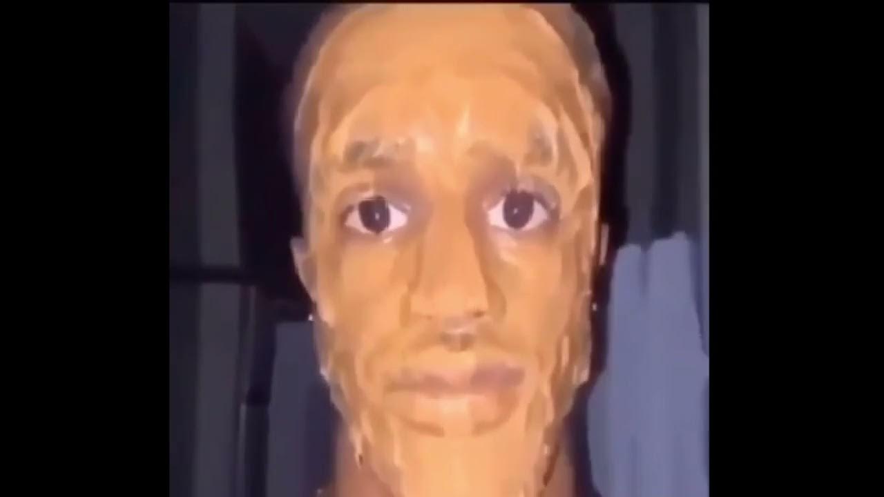 black man face covered in peanut butter looking at the camera ominously
