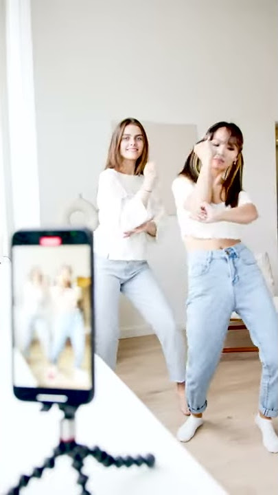 two young girls dancing front of mobile/Copyright free videos