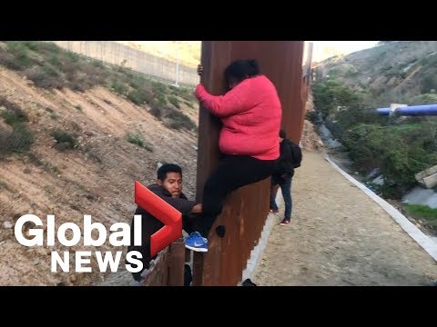 Migrant families continue to spill over Tijuana border fence, head to U.S.