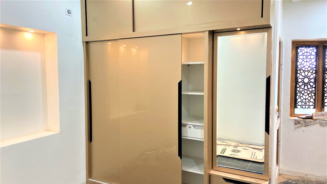 Latest Wardrobe Design for Bedroom with Acrylic Laminates & Auto LED